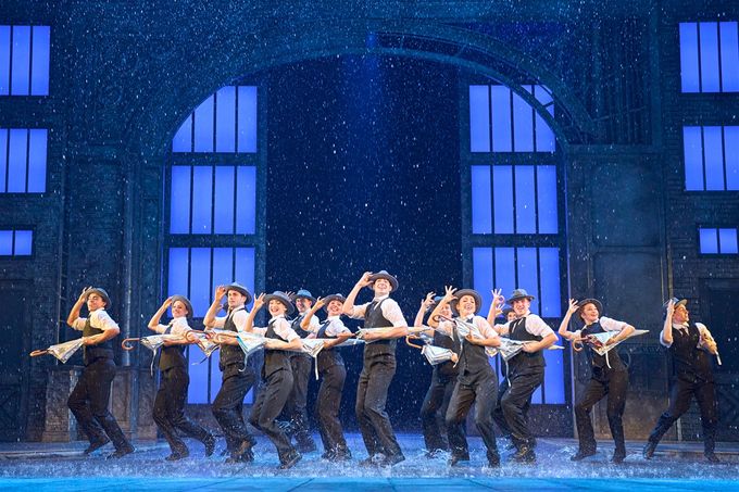 The cast of Singin' in the Rain get a soaking... and so does the front row of the stalls!